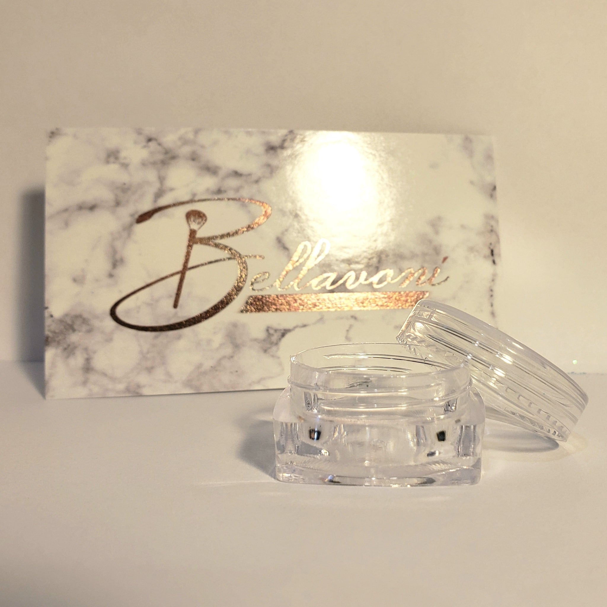 Clear jar with lid, marble pattern box with gold "Bellavoni" text