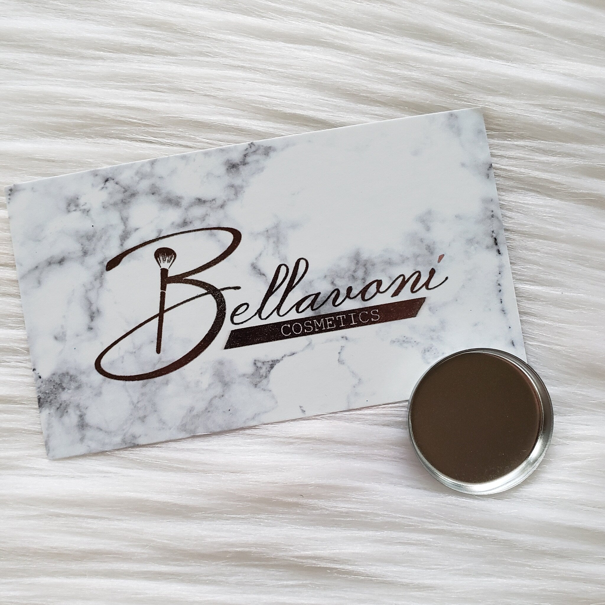 Close-up of pressed glitter eyeshadow palette with vibrant jewel tones and shimmer finish in gold packaging