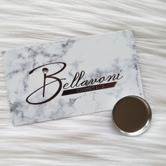 Close-up of pressed glitter eyeshadow palette with vibrant jewel tones and shimmer finish in gold packaging
