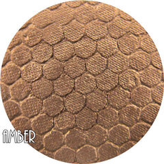 Pressed mineral eye shadow in warm amber hue with smooth matte finish, displayed in compact case.
