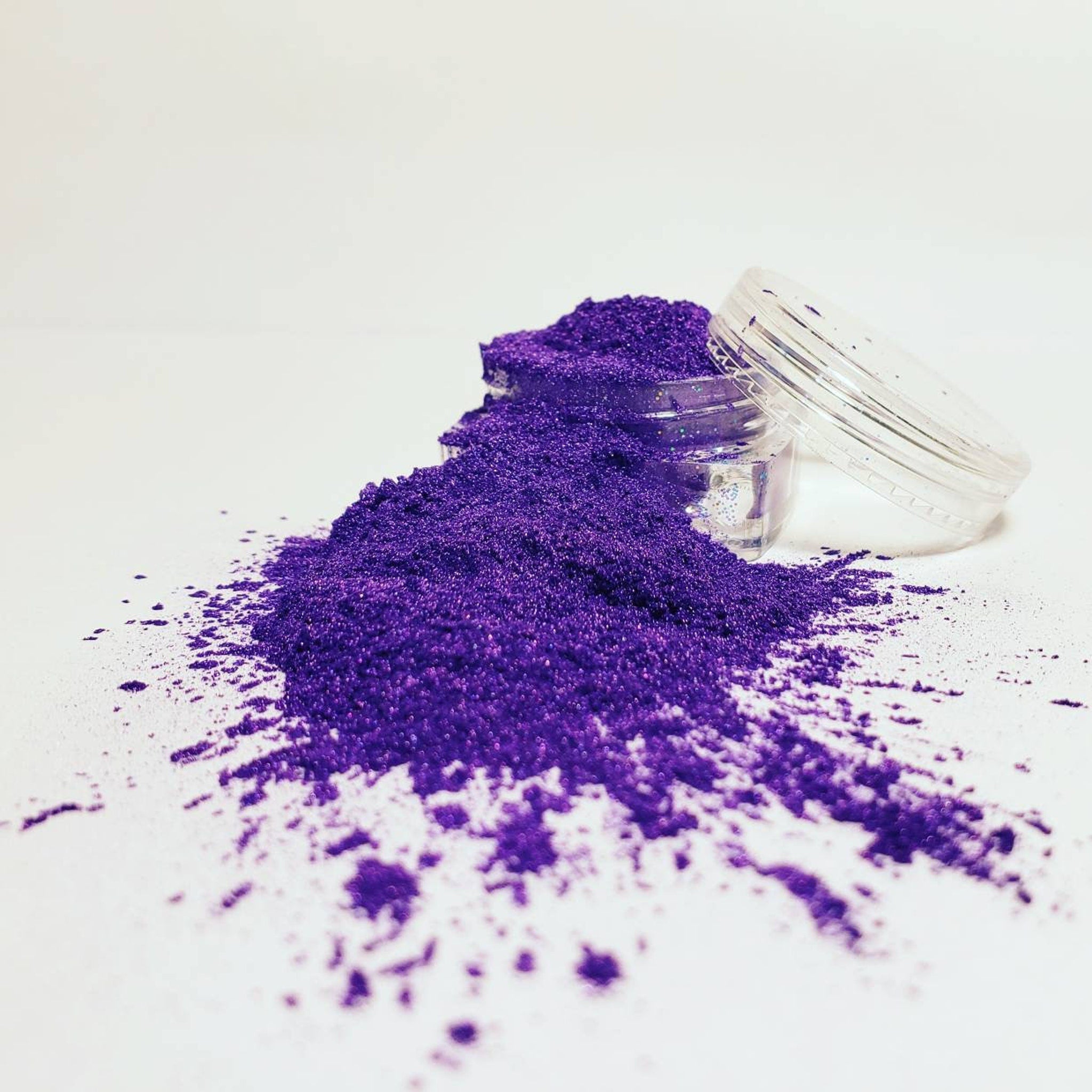 Hand applying shimmering taupe mineral eyeshadow with a fluffy brush for a reflective finish