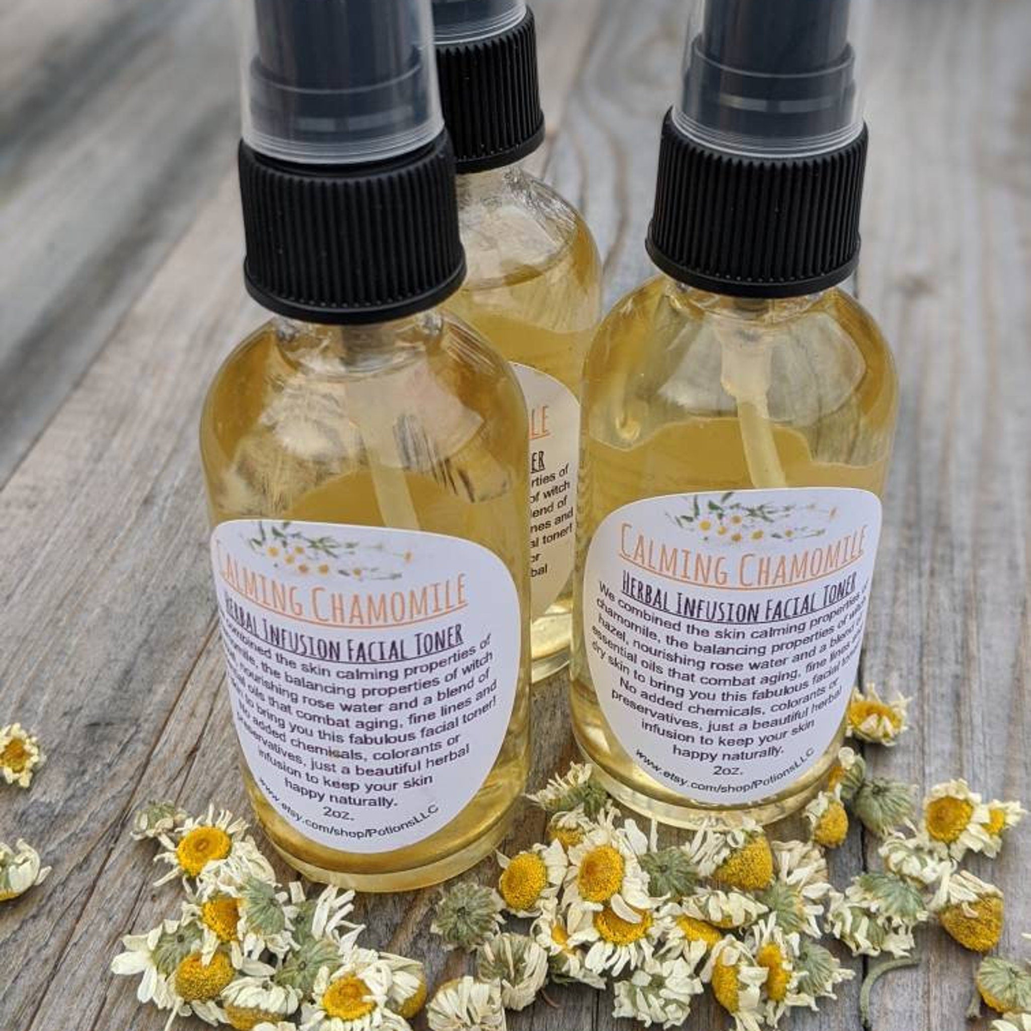 Facial toner bottles with black spray tops, yellow liquid, and white labels on wood surface