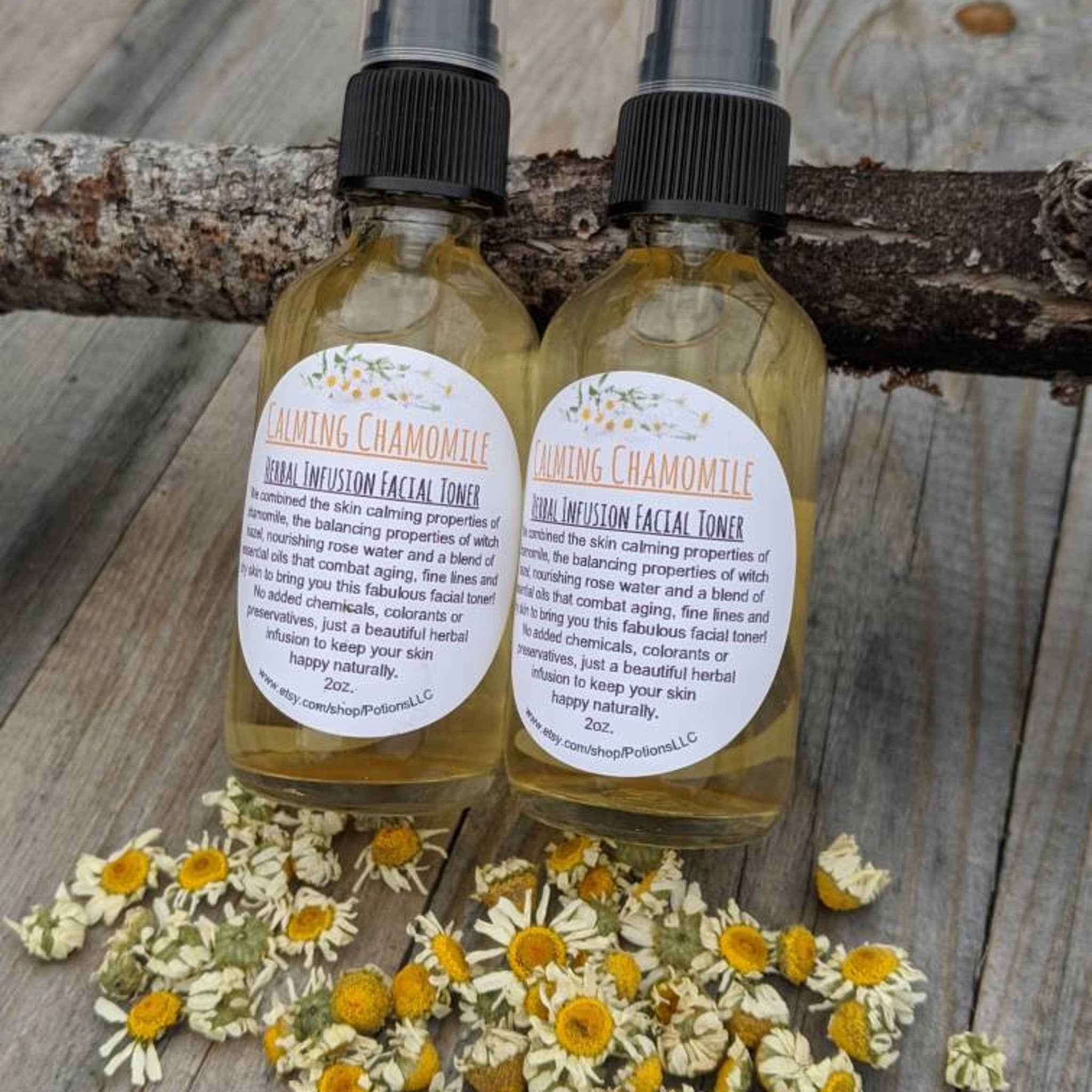 Facial toner bottles with yellow liquid, black spray tops, and white labels on wooden surface