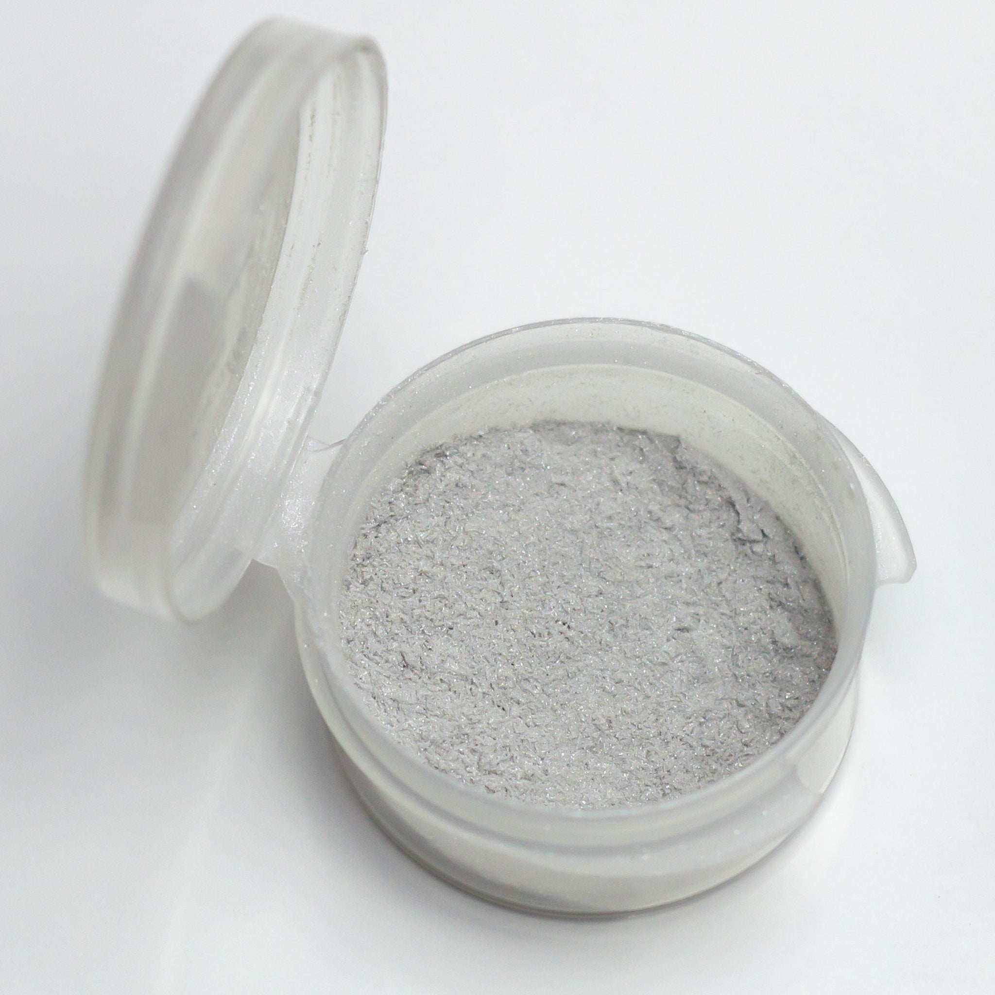 Silver glitter powder in clear plastic container with open lid