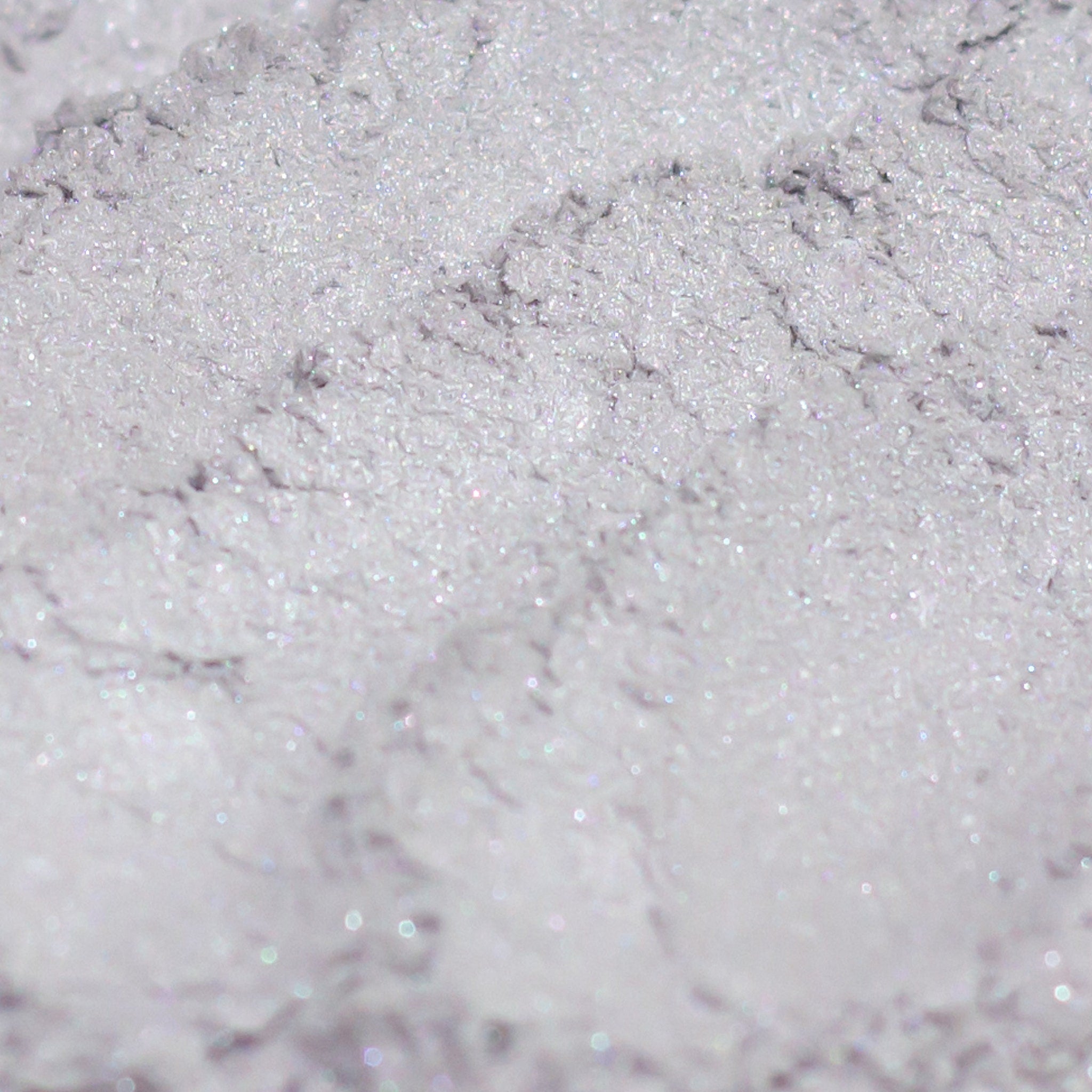 Eyeshadow silver gray with lavender shimmer, close-up of textured powder