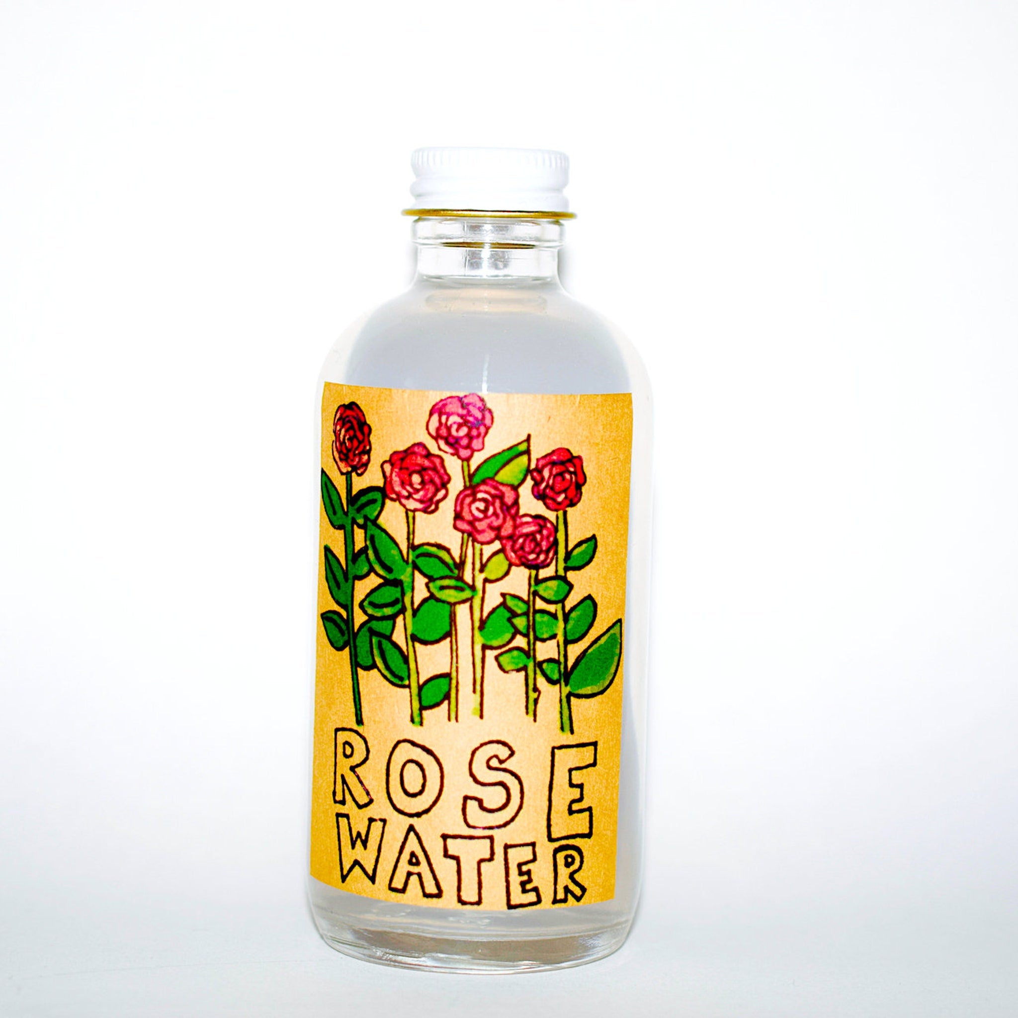 Rose water bottle with white cap, clear glass, and floral label with text "Rose Water