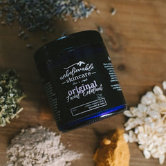 Facial Cleanser jar, black glass, white text "original Facial Exfoliant" on label, surrounded by ingredients