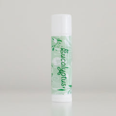 Eucalyptus lip balm with white cap and green patterned label, Forest Hills Remedies text visible