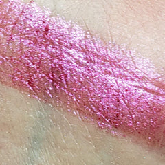 Side view of four round eyeshadow pans in shimmering bronze, plum, gold, and taupe hues with embossed logo