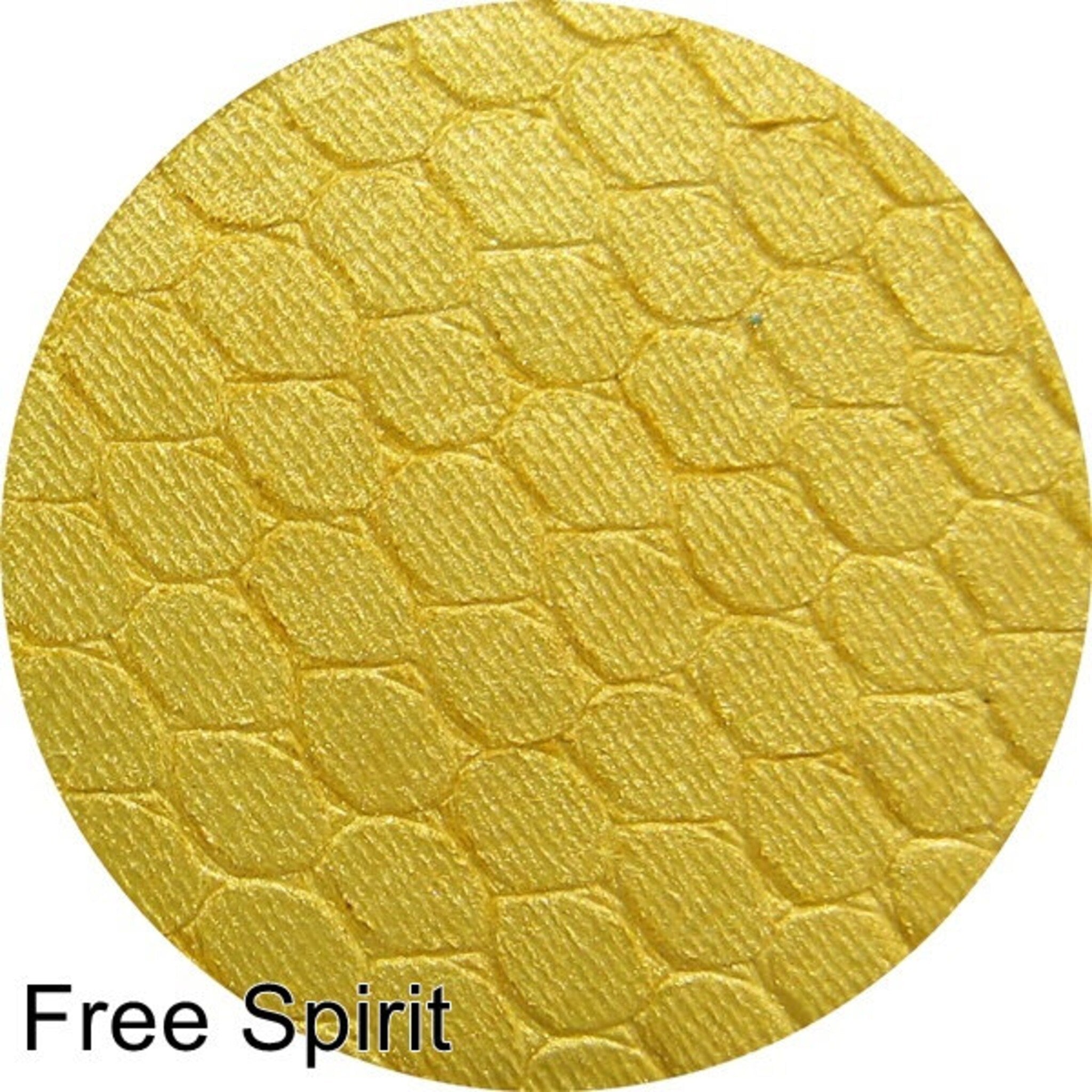 Silk FX Free Spirit pressed eyeshadow in a vibrant peachy-gold shade with smooth satin finish, shown in compact.