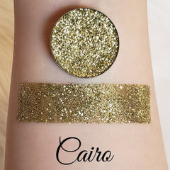 Close-up of Bellavoni pressed glitter eyeshadow in Cairo shade with shimmering gold and bronze particles