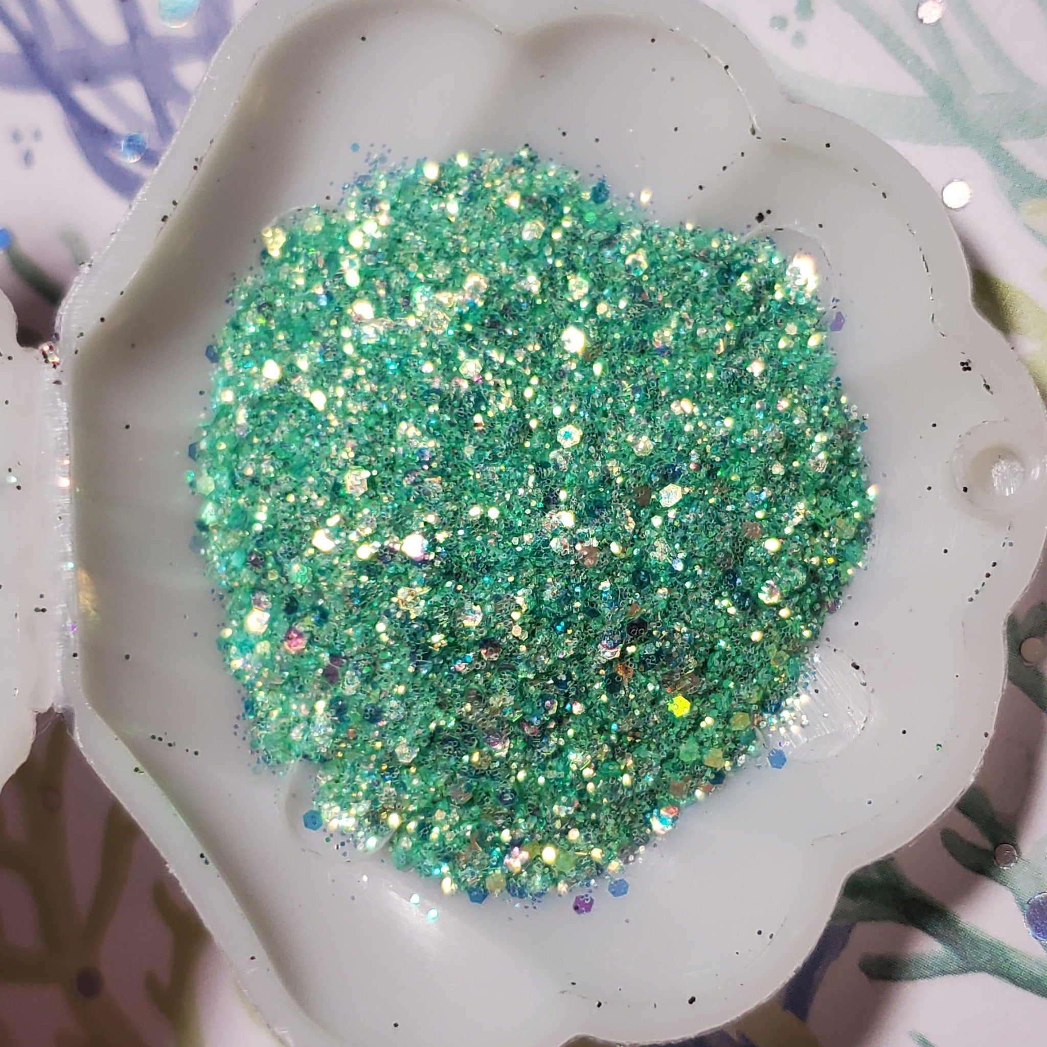 Shimmering mermaid teal gel eyeshadow in a sleek silver tube with doe-foot applicator
