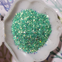 Shimmering mermaid teal gel eyeshadow in a sleek silver tube with doe-foot applicator