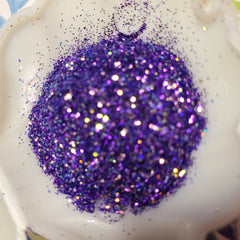 Psylocke glitter eye shadow gel in a sleek tube with vibrant shimmer particles visible through clear packaging