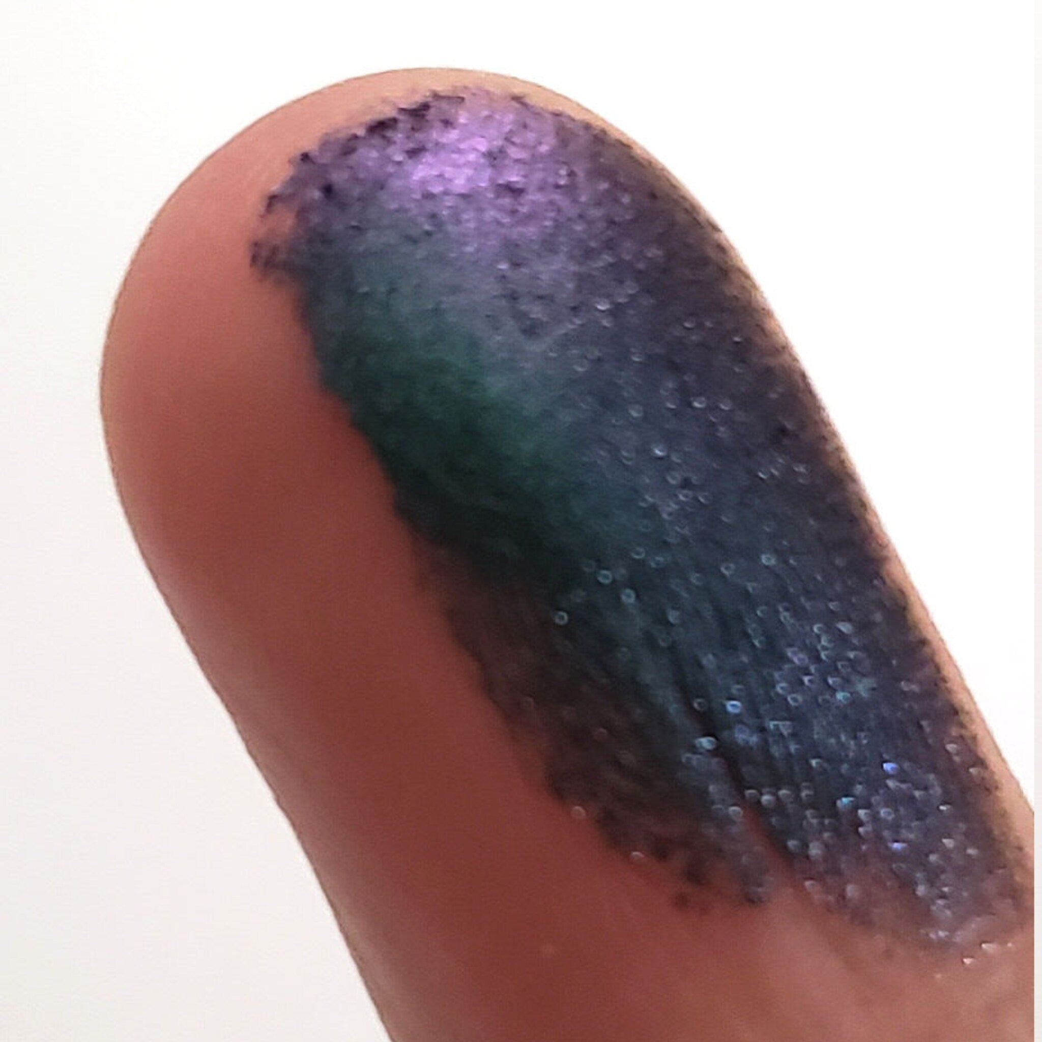 Close-up of Fuse Eye Shadow pan showing shimmering bronze pigment with smooth, blendable texture