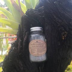 White ceramic jar of ultra detoxifying clay face mask with gold lid and minimalist label