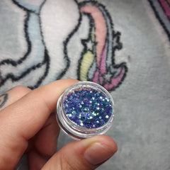 Side view of iridescent mermaid scales eye shadow palette showcasing multi-color shimmer gradient