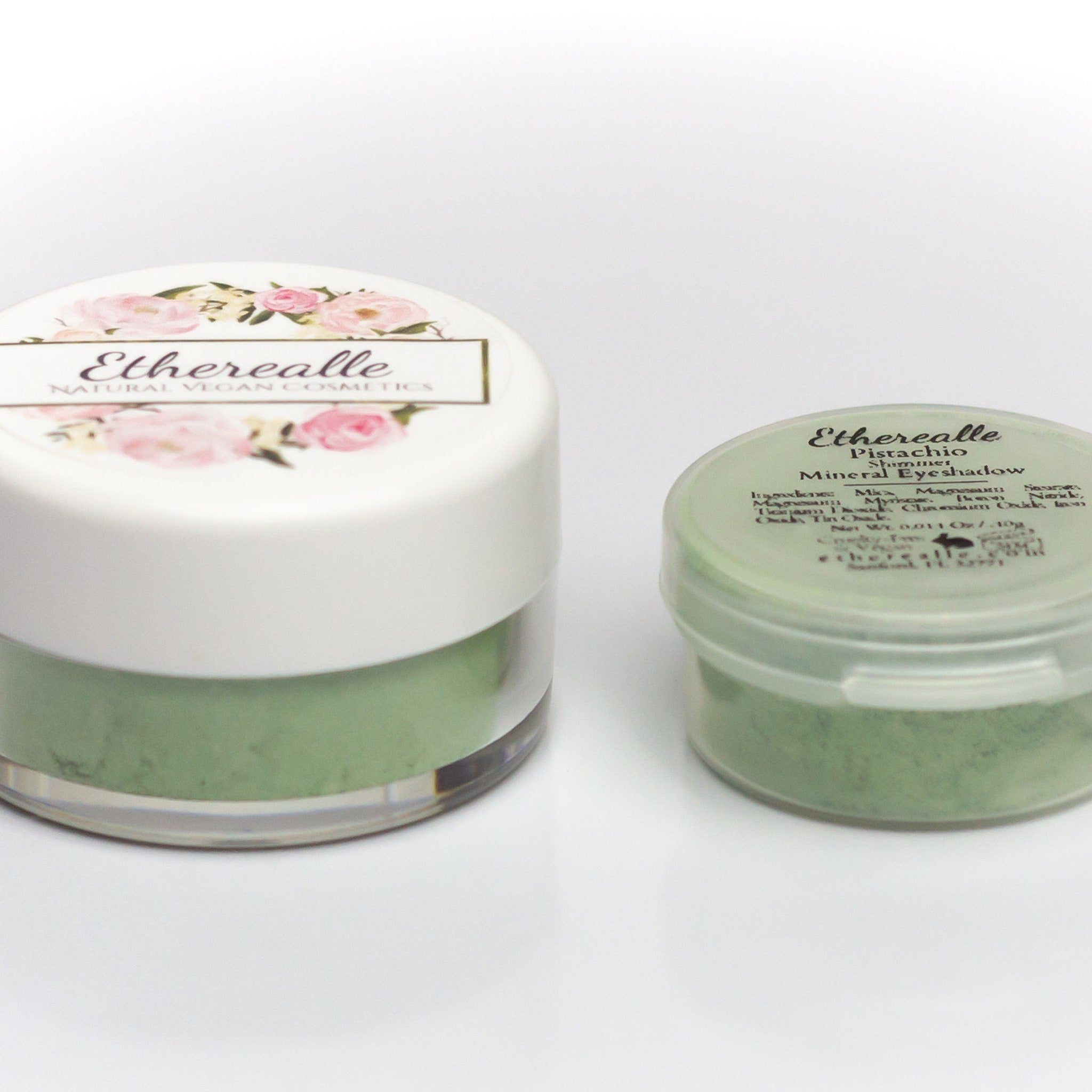 Shimmery pistachio green eyeshadow compact with mirrored lid and gold branding on sleek black case