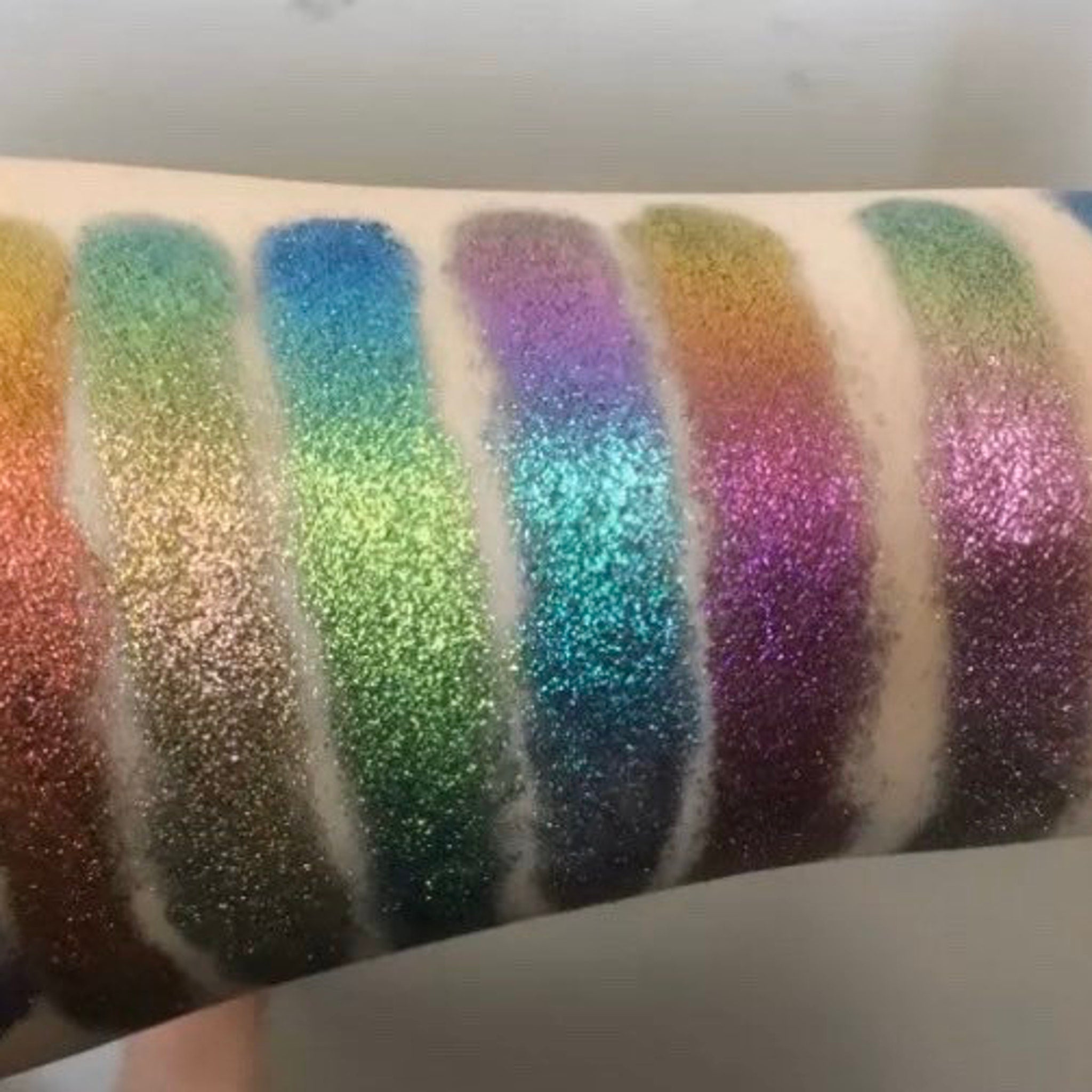 Side view of Tala Foil Thunderstorm Eye Shadow Pigment in metallic silver-blue shade with reflective foil finish