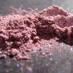 Powdered pigment in mauve color with sparkle effect, close-up view