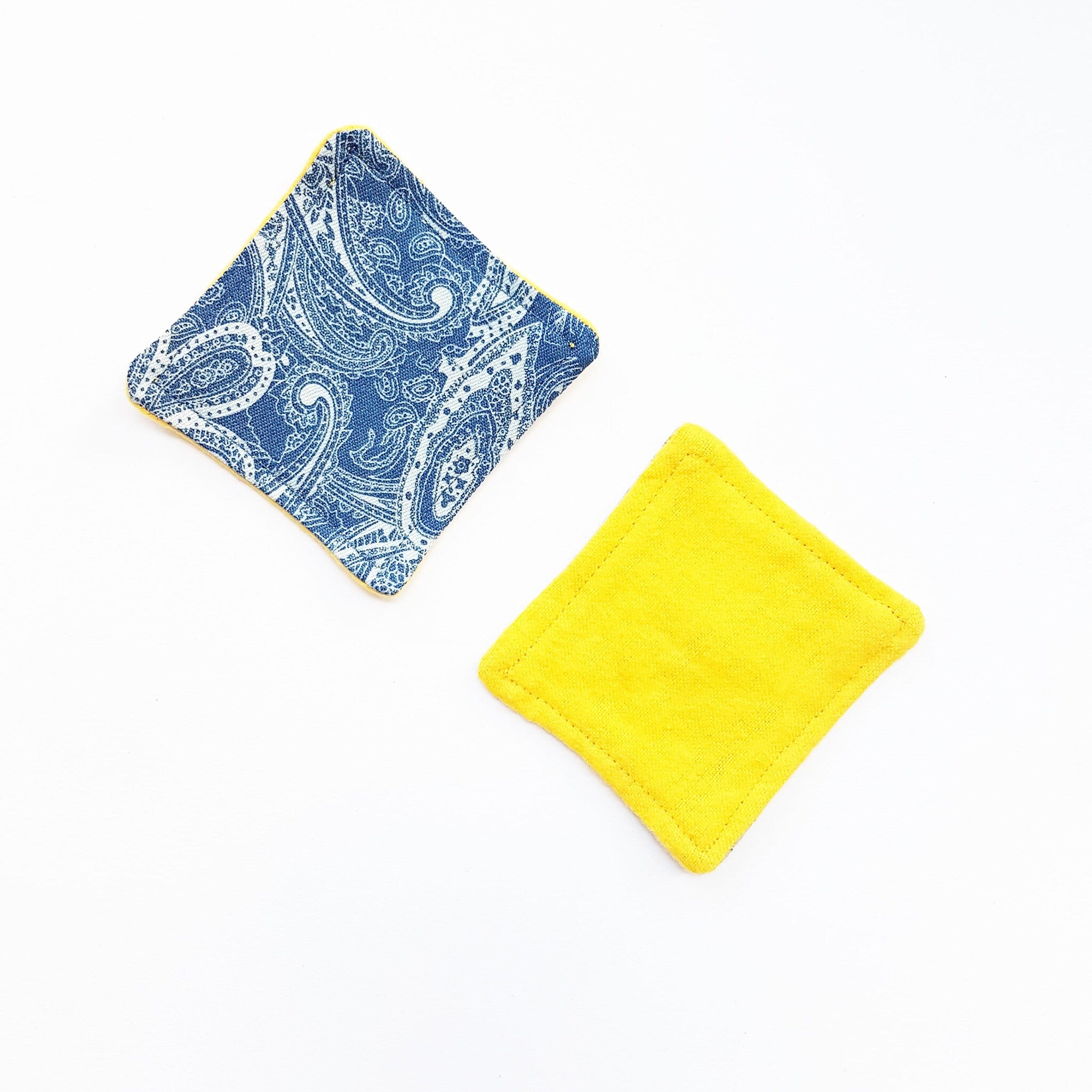 Cloth coasters, blue paisley pattern, yellow border, and solid yellow square shape