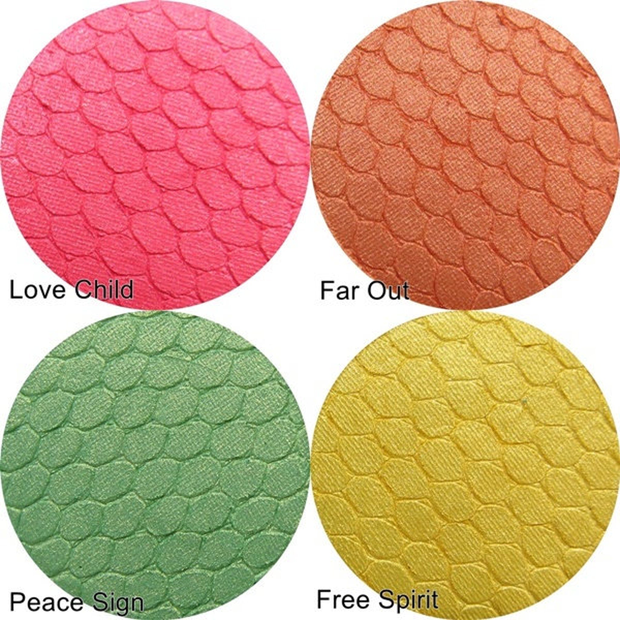 Eyeshadow palettes with pink, orange, green, and yellow textured powder in round pans
