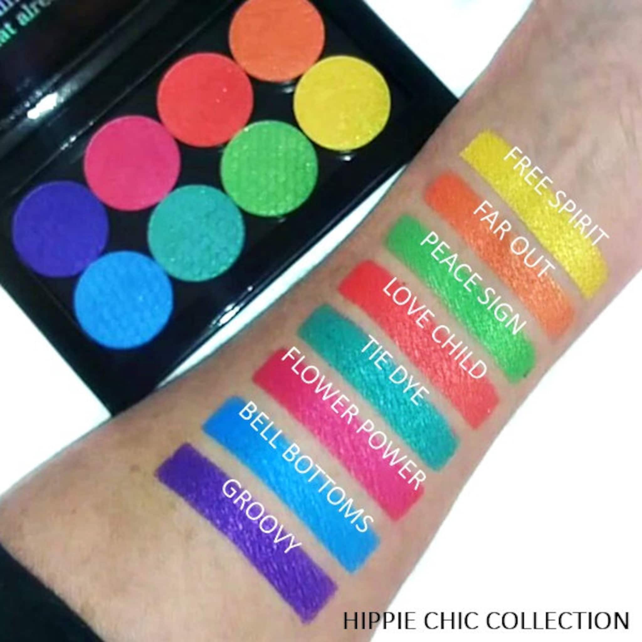 Eyeshadow palette with colorful circular pans and arm swatches, "Hippie Chic Collection" text visible