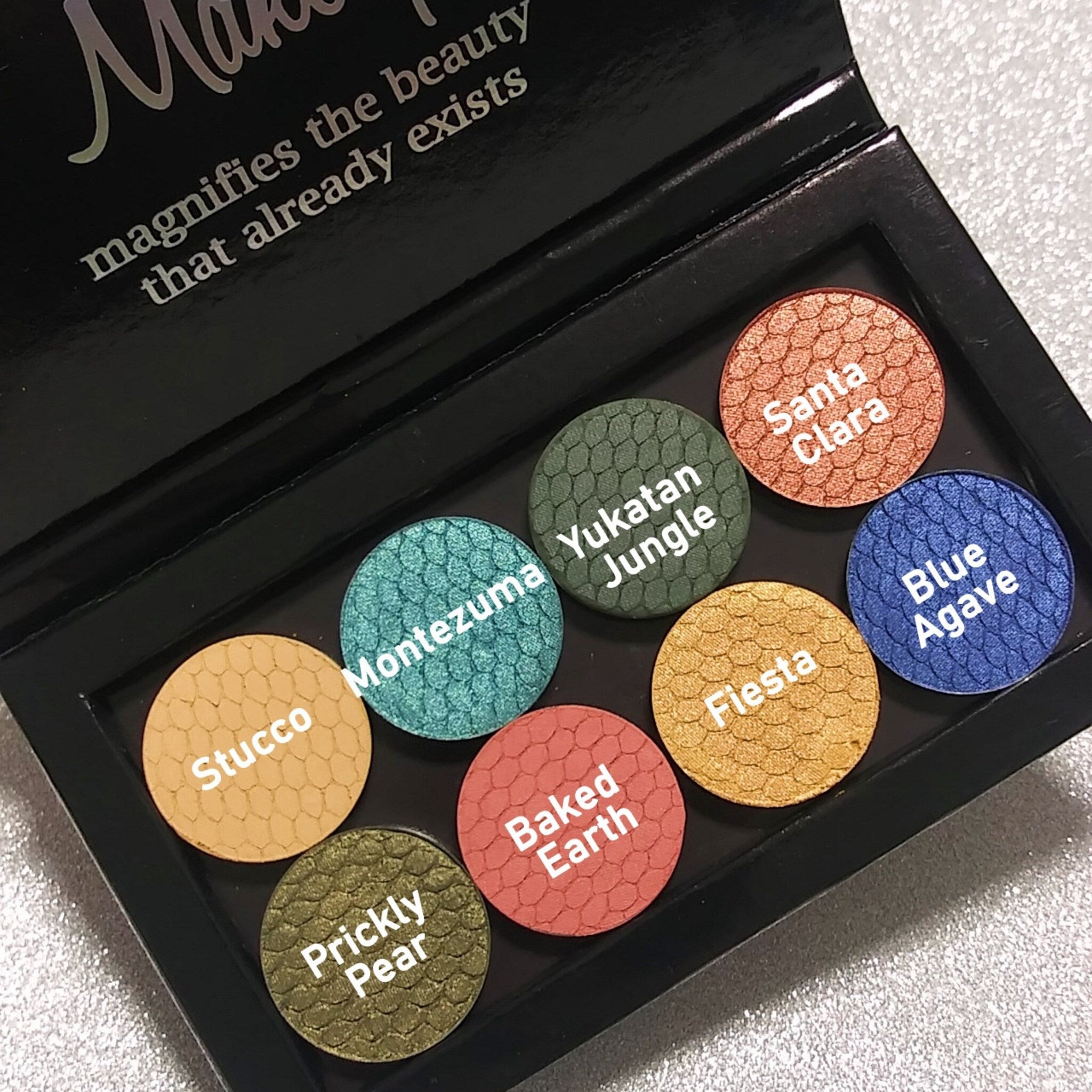 Side view of Silk FX Pressed Eye Shadow in Fiesta showing vibrant orange shimmer and smooth pressed powder texture