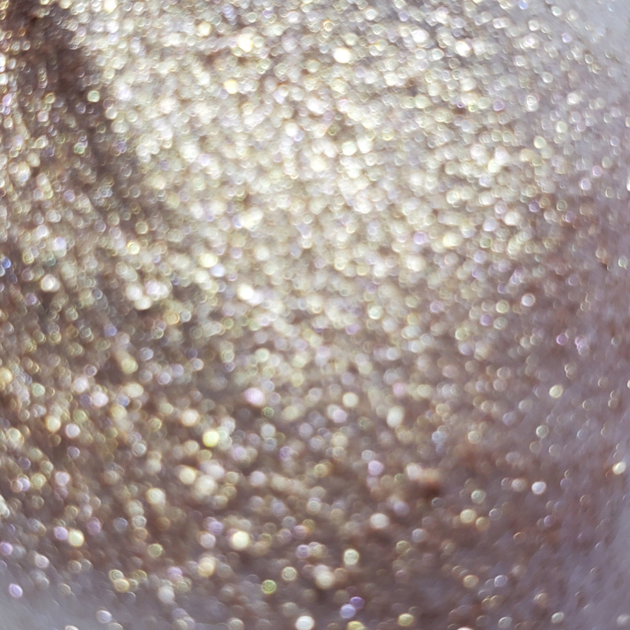 Open compact showing Dobby Eye Shadow with shimmering bronze and taupe powder squares in sleek black case