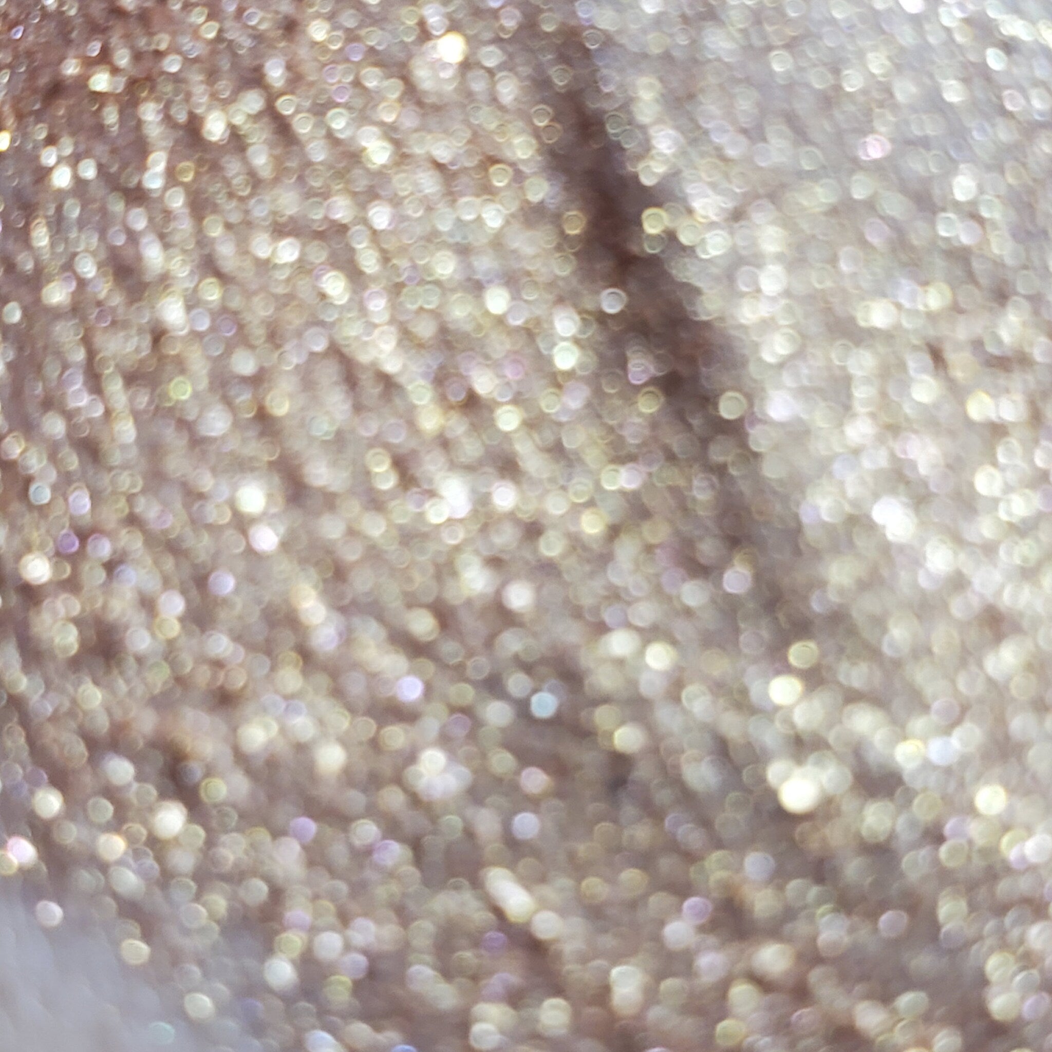 Close-up of Dobby Eye Shadow palette showing shimmering bronze and taupe powder textures