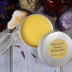 Healing salve in open metal tin, yellow balm, with Hayes Haven Apothecary label visible