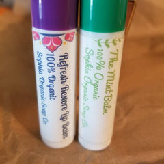 Lip balm tubes with purple and green caps, white label, and Sophia Organic Soap Co. text