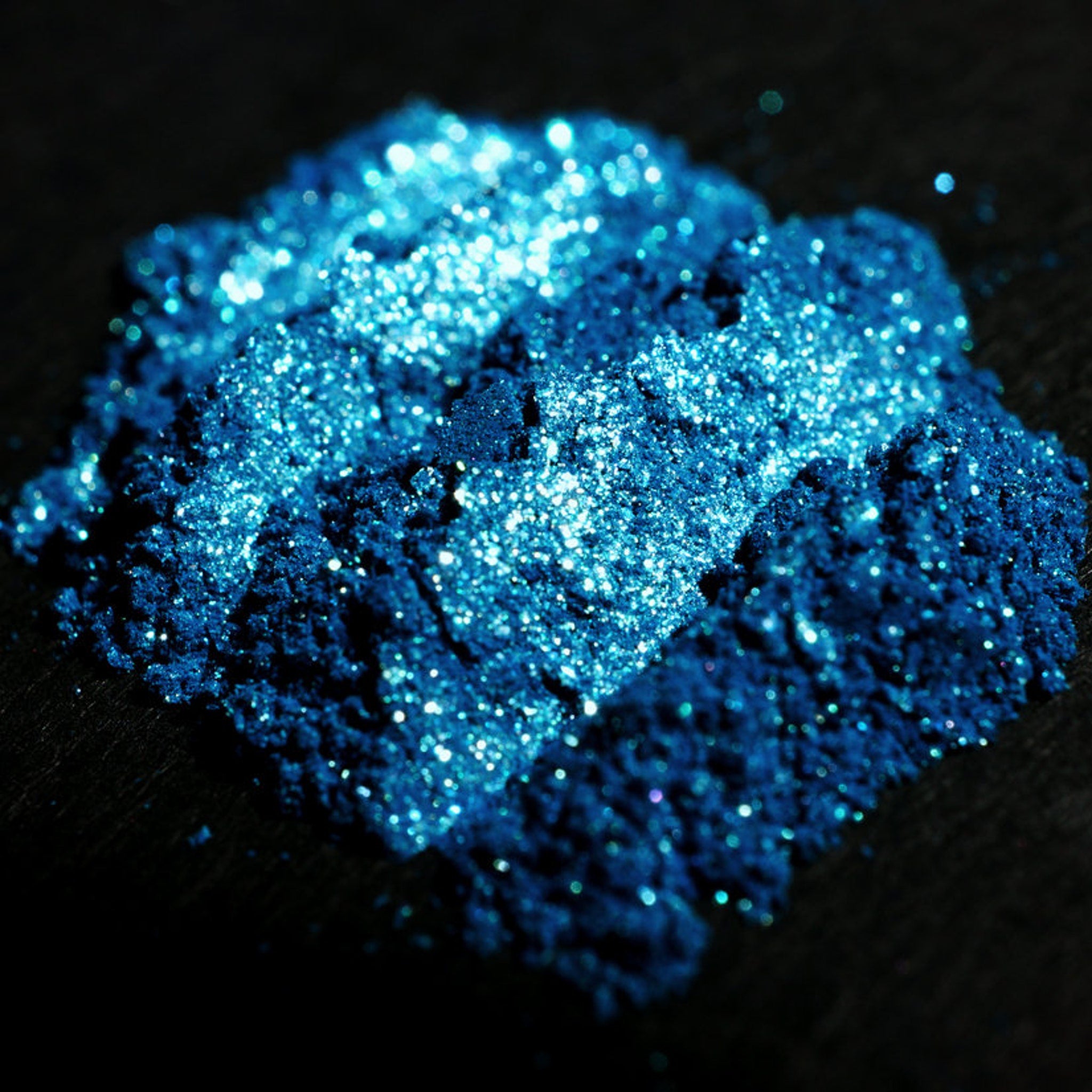 Open jar of teal shimmer loose eyeshadow with turquoise and green glitter, vegan mineral makeup