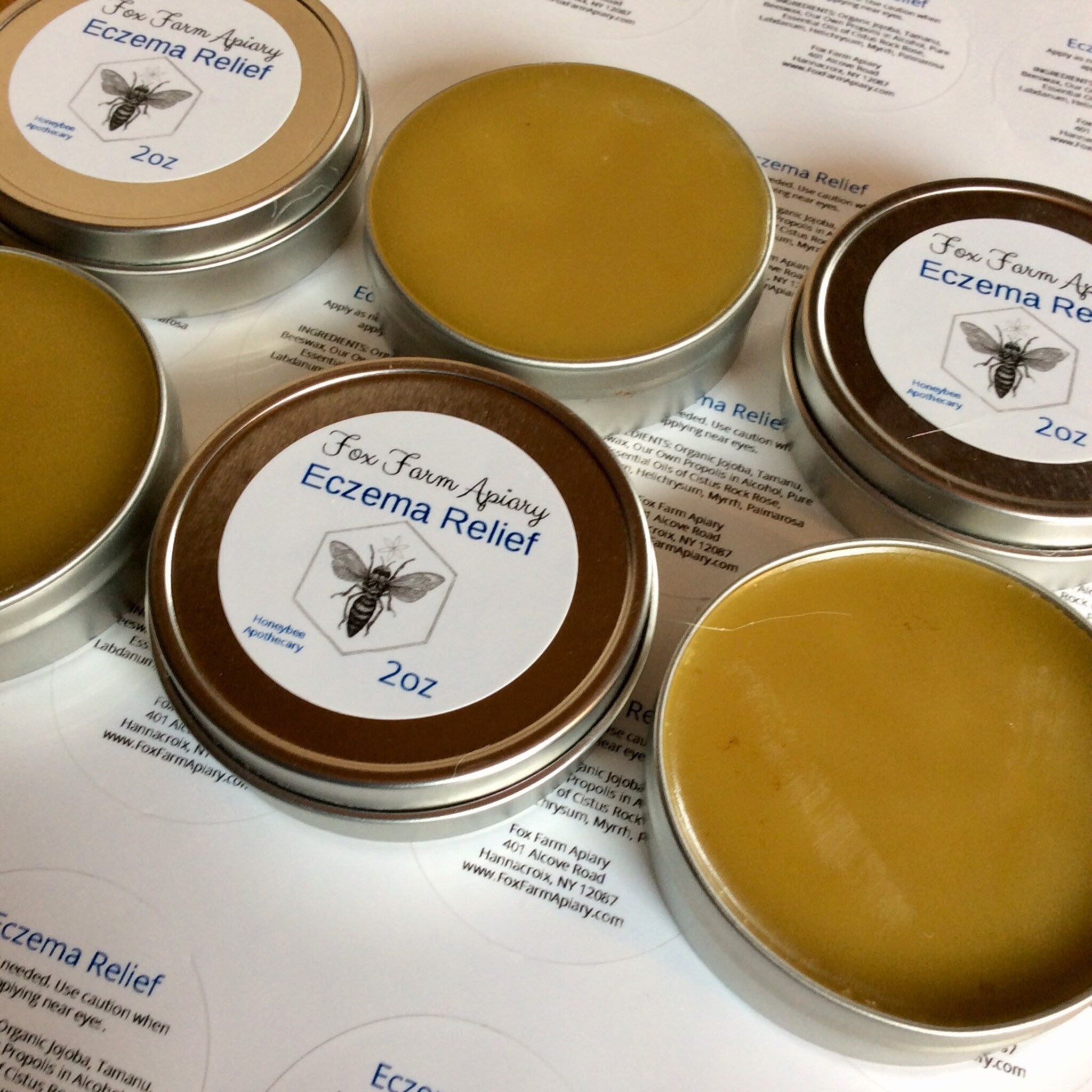 Eczema relief balm in metal tin with brown lid and yellow balm, Fox Farm Apiary label