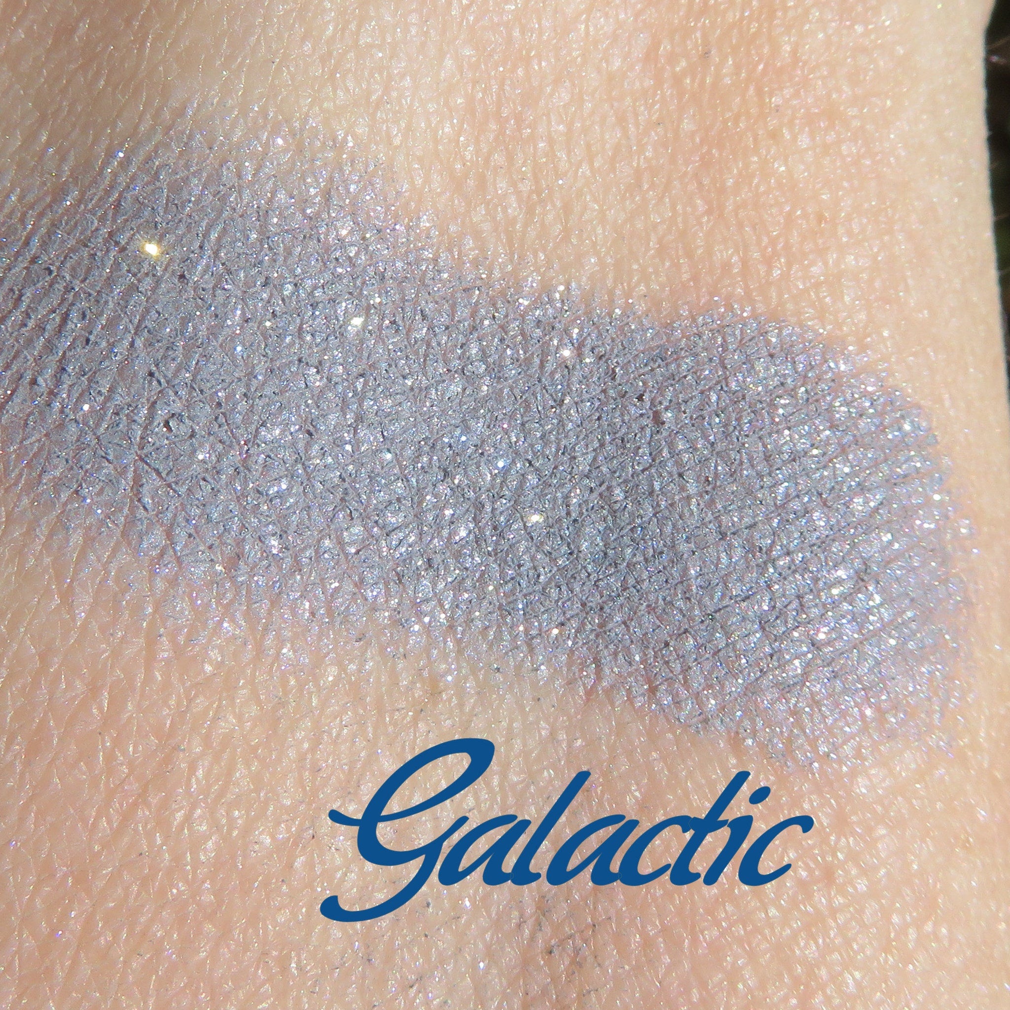 Side view of Galactic Blue Gray loose mineral eyeshadow with sparkling shimmer in a clear jar