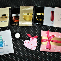 Avon sample pack with pink gift wrap, red ribbon, and polka dot pattern
