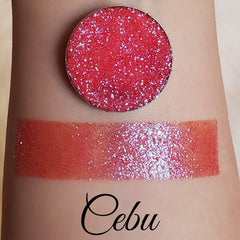 Close-up of pressed glitter eyeshadow in a magnetic pan with vibrant shimmer particles