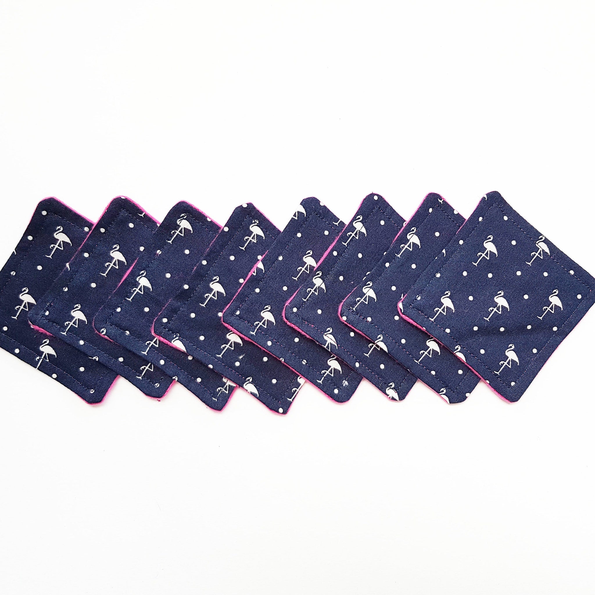 Coasters, navy fabric with white flamingo pattern and pink trim, set of eight