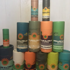 Skin care products in various colors with Sunmade Naturals labels, stacked in cylindrical containers