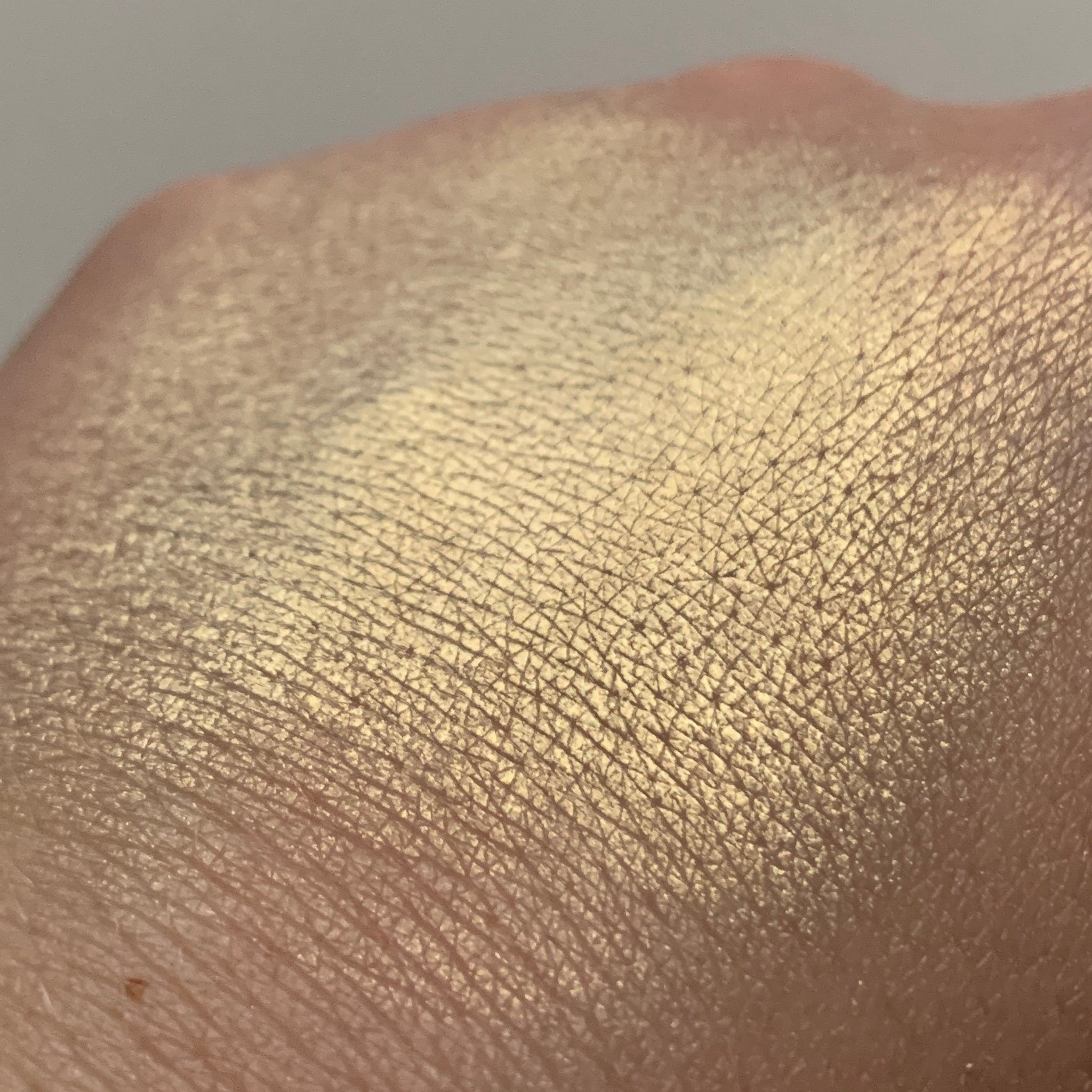 Gold shimmer on skin, showing texture and light reflection