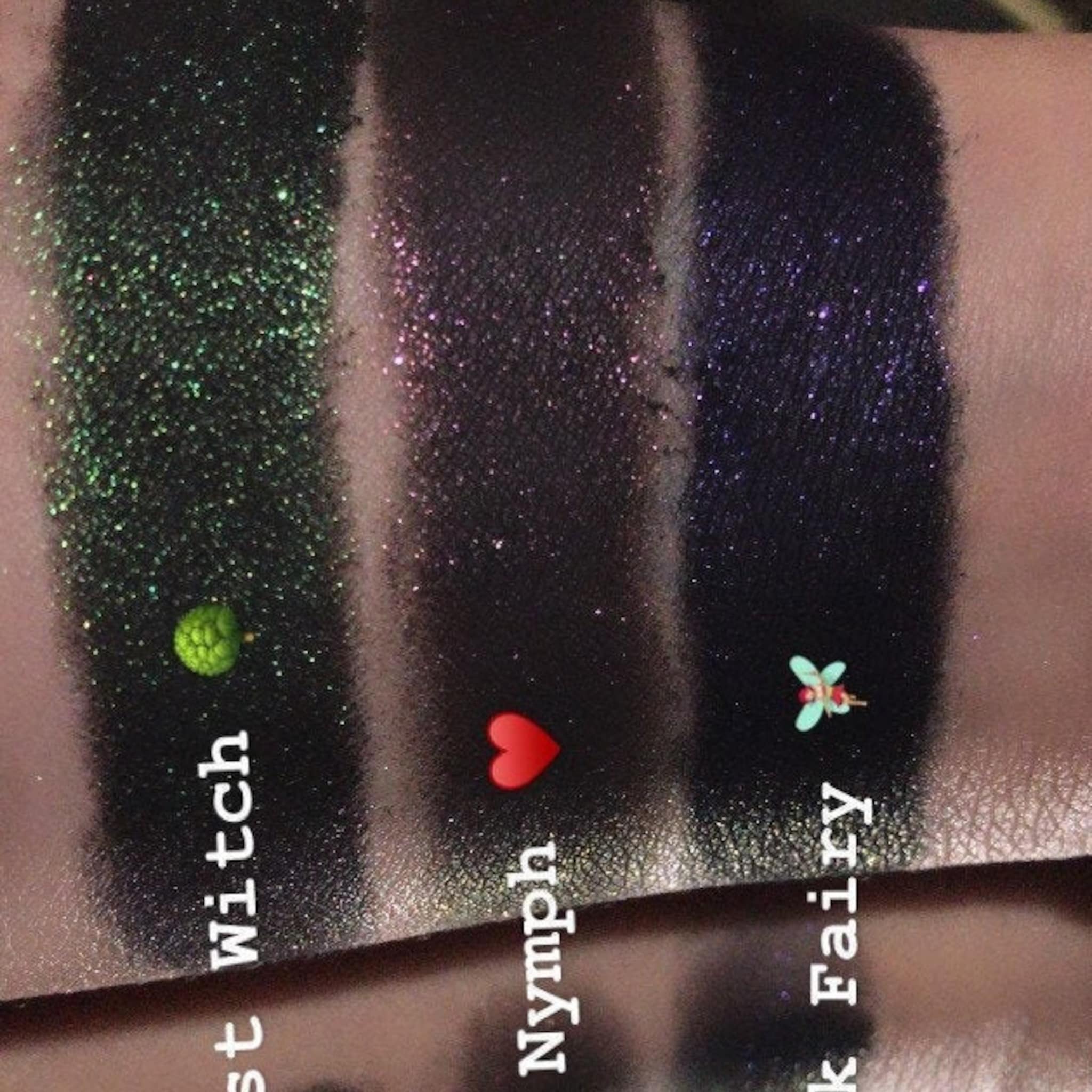 Eye shadow swatches with green, pink, and purple glitter on skin, Smudg'D Dark Trio
