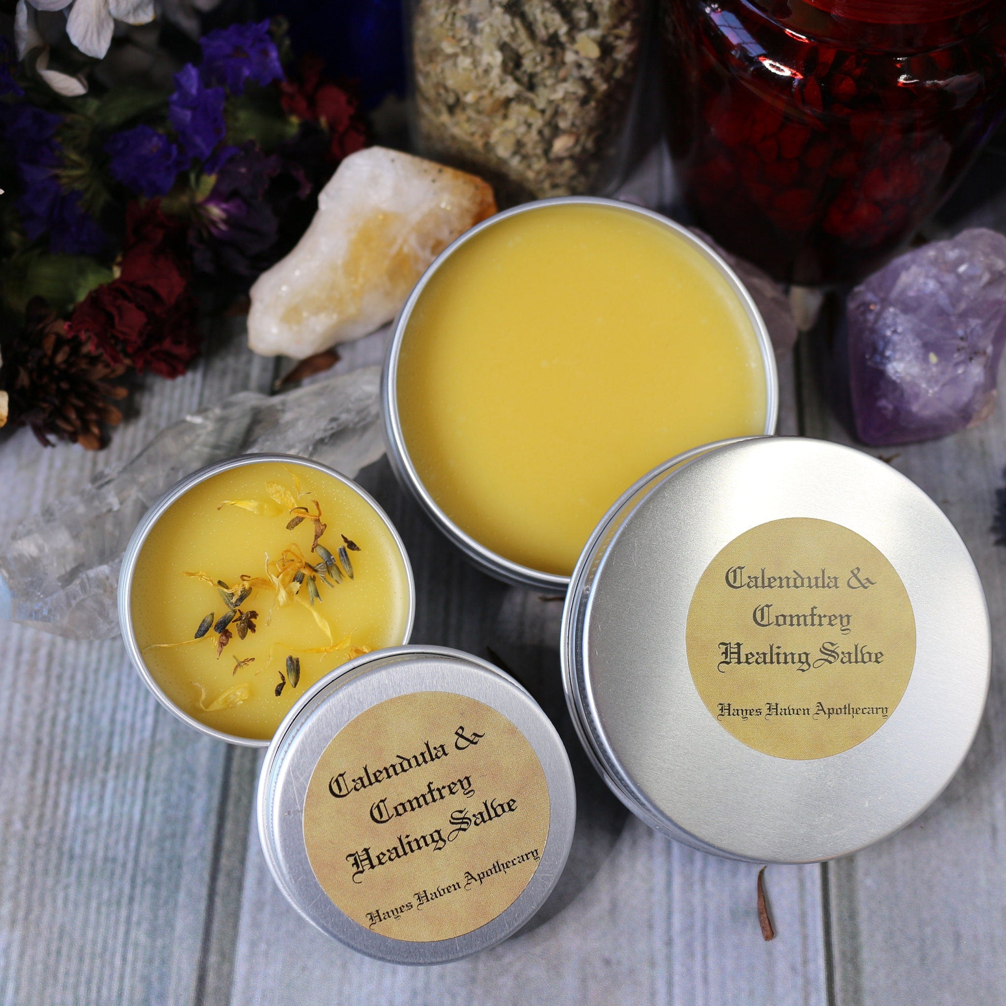 Healing Salve tins with yellow balm, silver metal, and Hayes Haven Apothecary label