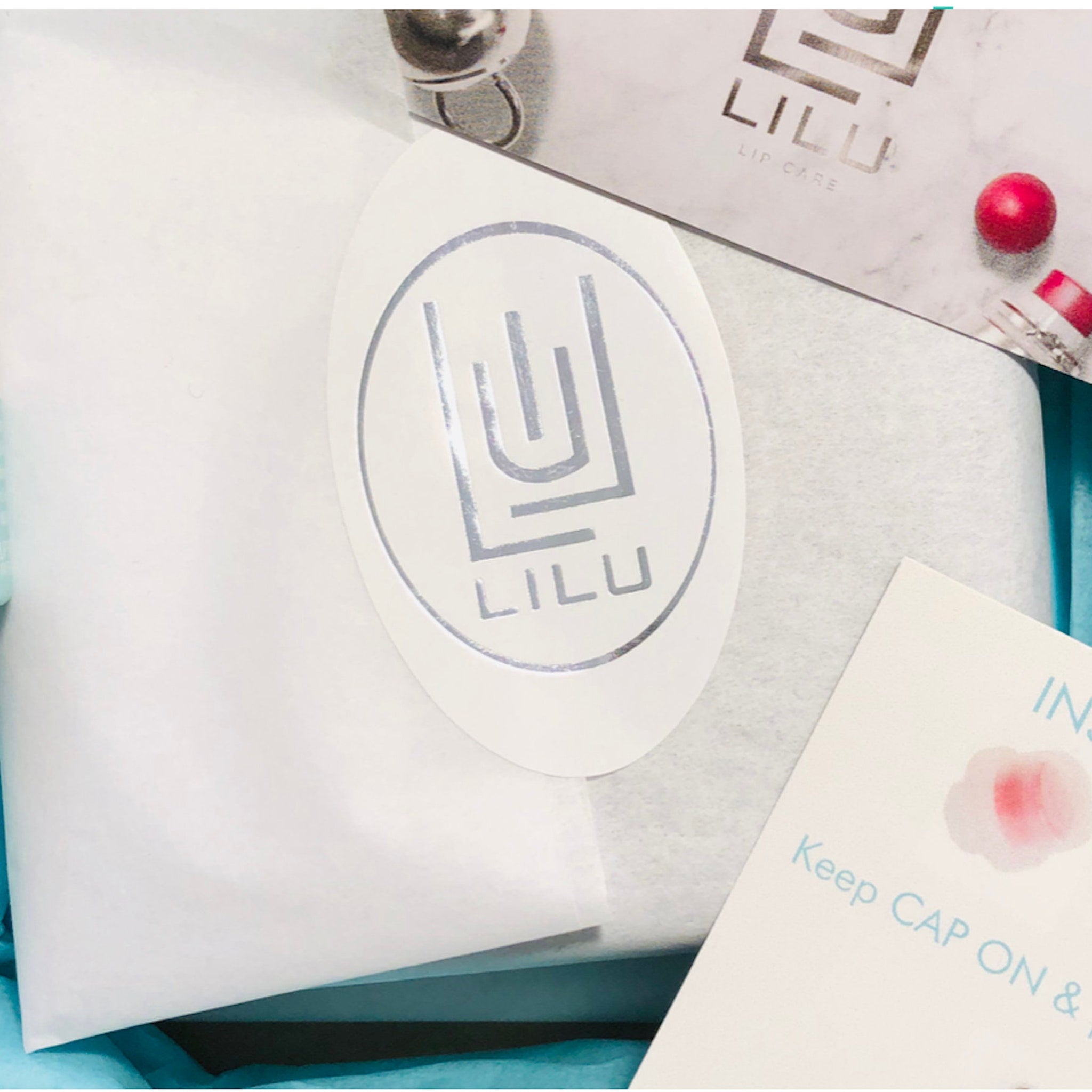 LILU branded oval sticker with silver logo on white paper, packaging with instructions