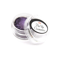 Close-up of dark purple vegan mineral eye shadow with shimmering finish in compact case