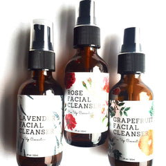 Facial cleanser bottles, brown glass with black pump tops, white labels with floral designs, Pin Up Cosmetics