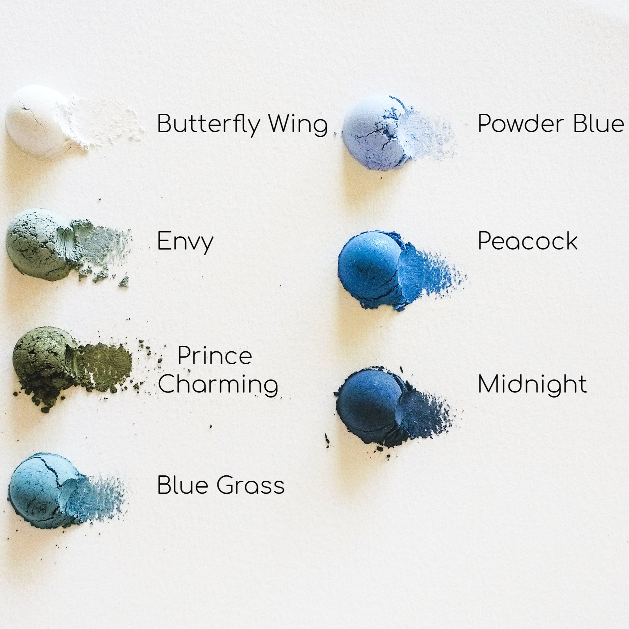 Makeup swatches with various blue shades, including Butterfly Wing, Powder Blue, and Midnight, on white background