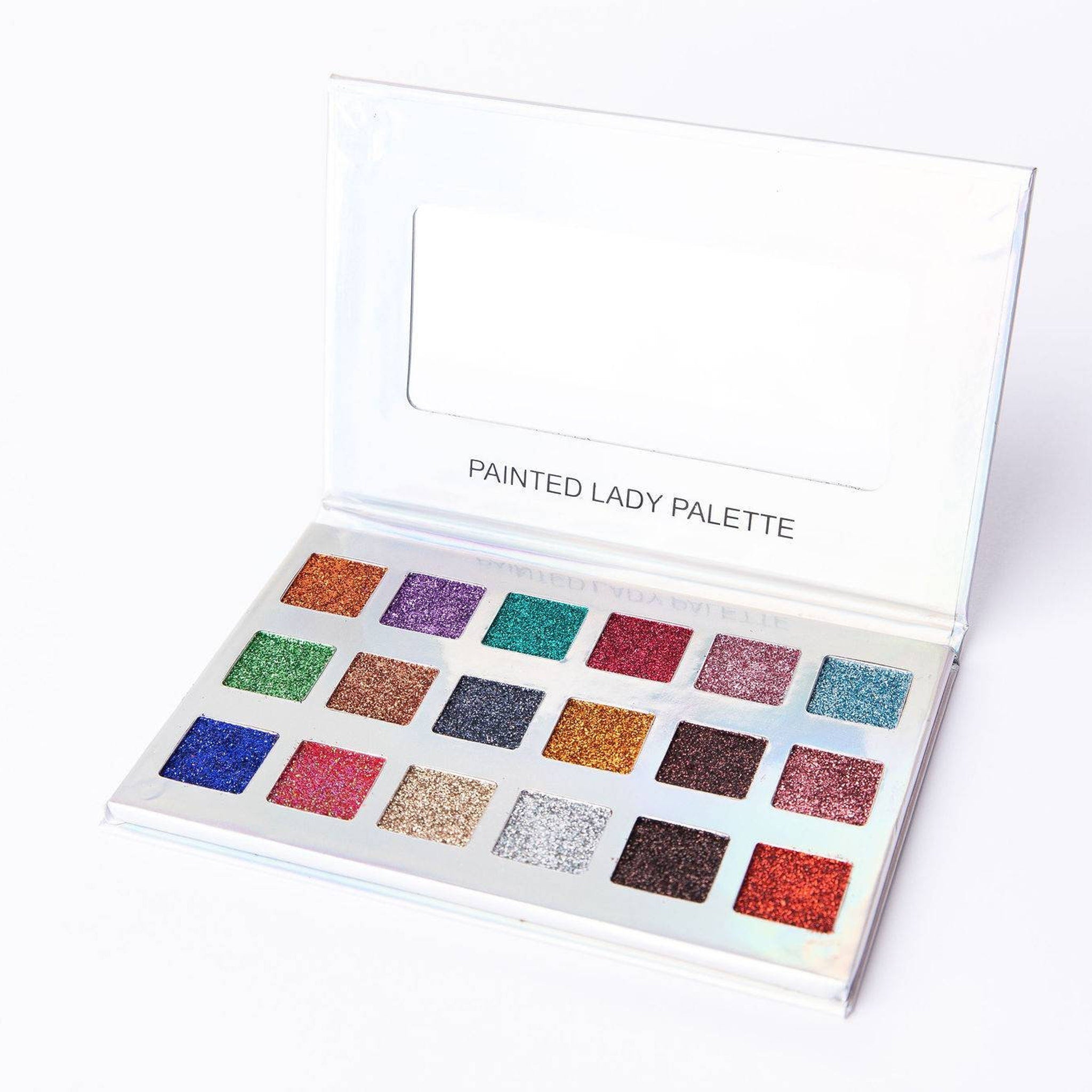 Close-up of vibrant glitter eyeshadow palette with shimmering pink and gold shades in sleek black compact