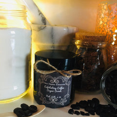 Exfoliating coffee sugar scrub in black jar with label, tied with twine, and coffee beans