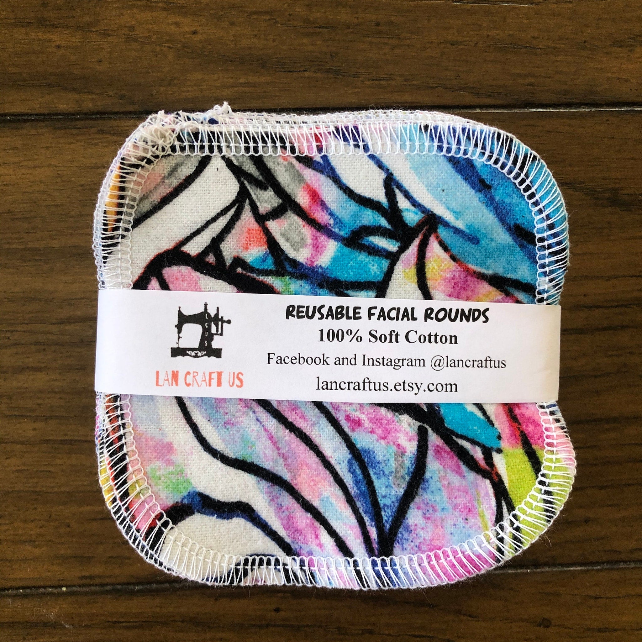 Reusable facial rounds with colorful floral pattern and white stitched edge, by LAN CRAFT US