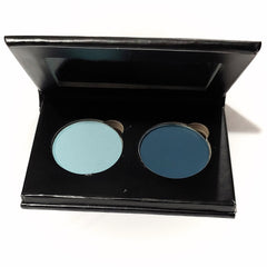 Pressed eye shadow duo with light blue and dark blue colors in a black palette